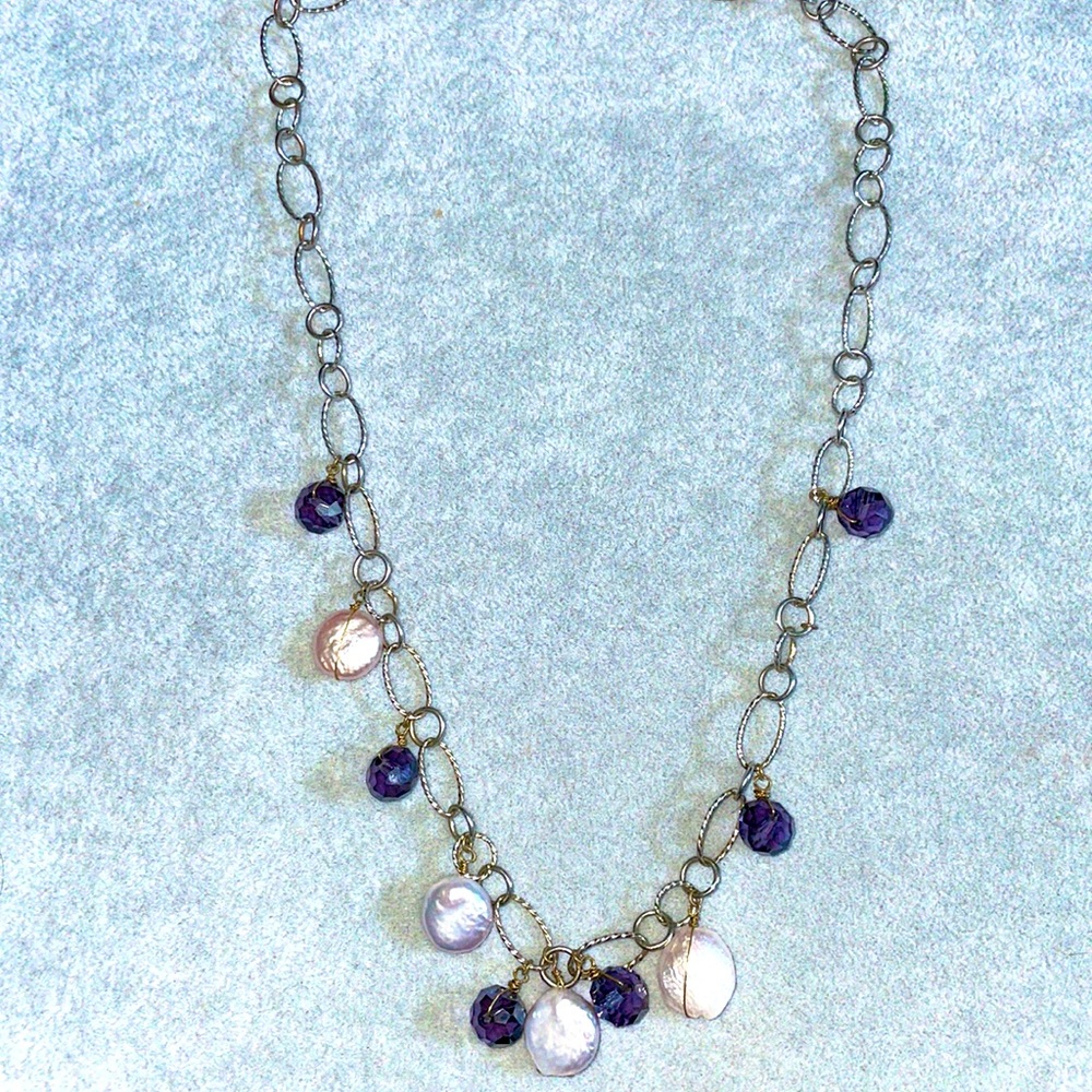 Plum purple and opal mother of pearl beads strung on a delicate silver chainlink